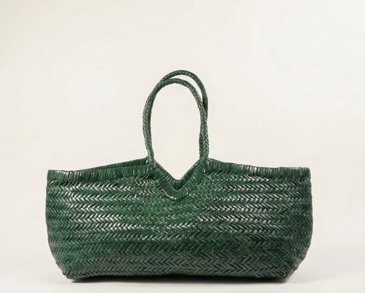 Green woven handbag on a light beige background