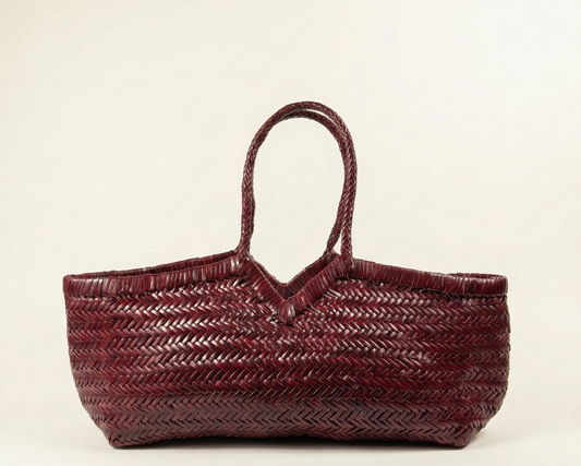 Woven handbag on a beige background