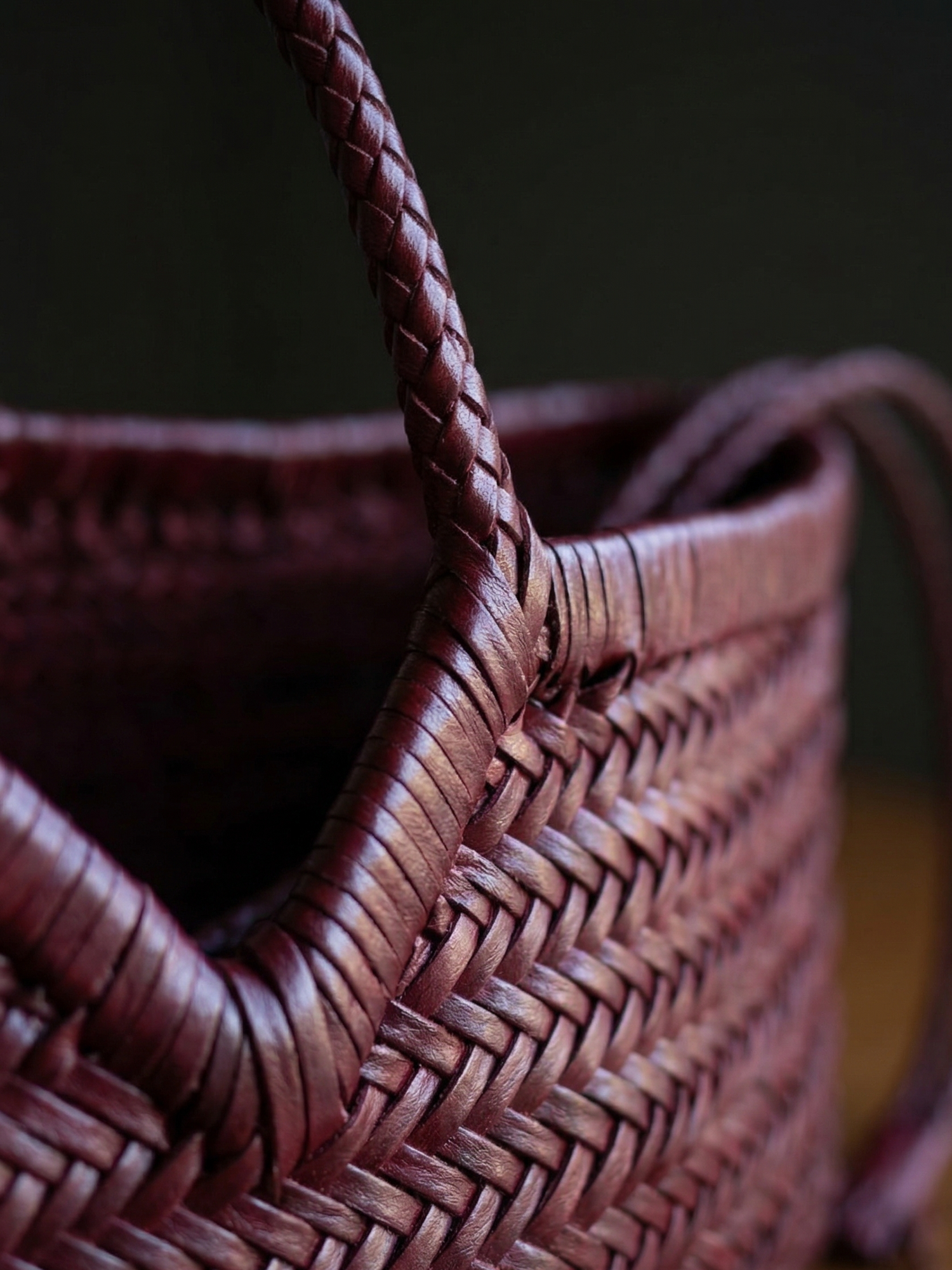 Close-up of a maroon bag with a dark background